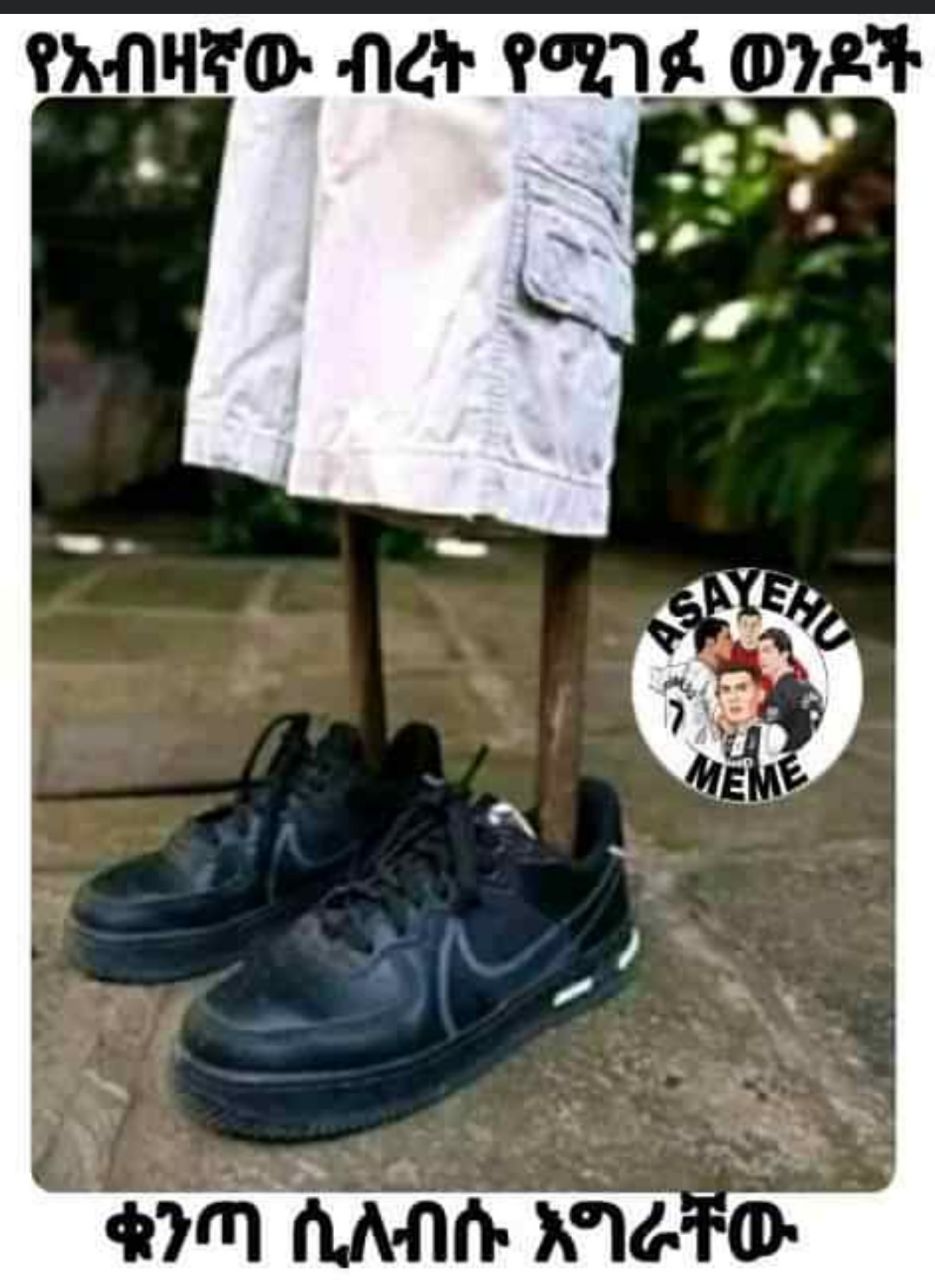 a pair of shoes with a man in the background